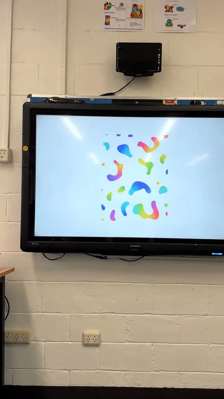 A large interactive display on a classroom wall