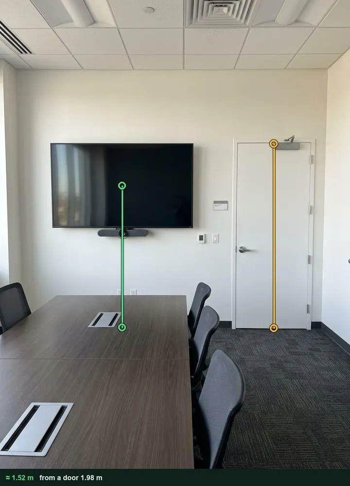 A boardroom end wall with a wall-mounted display and a door, marked up to give about 1.52 m from the floor to the centre of the screen against the 1.98 m door