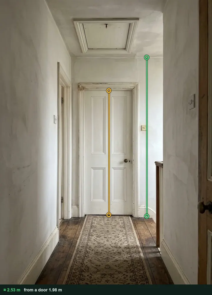 A landing with a loft hatch in the ceiling, measured from a photo at about 2.53 m above the floor using the bedroom door