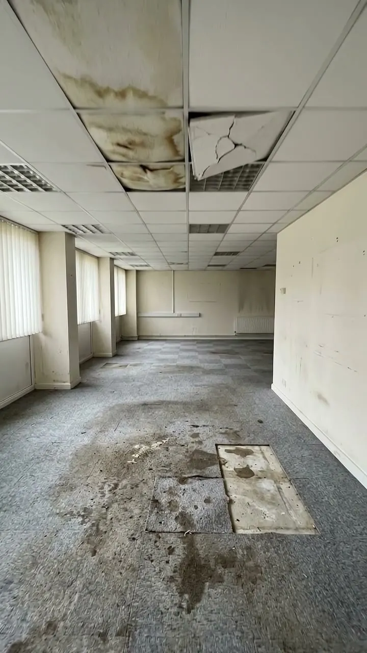 Stained office carpet tiles with gaps where tiles are missing