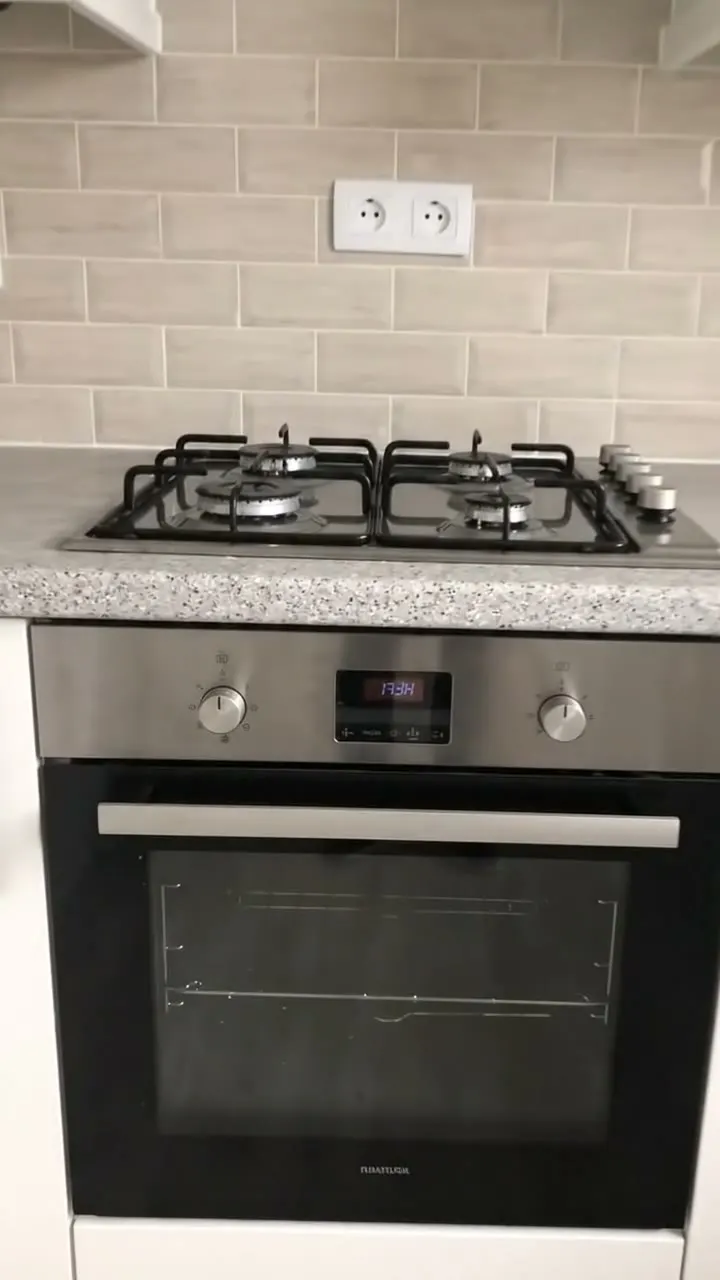 A built-in oven and hob in a fitted kitchen