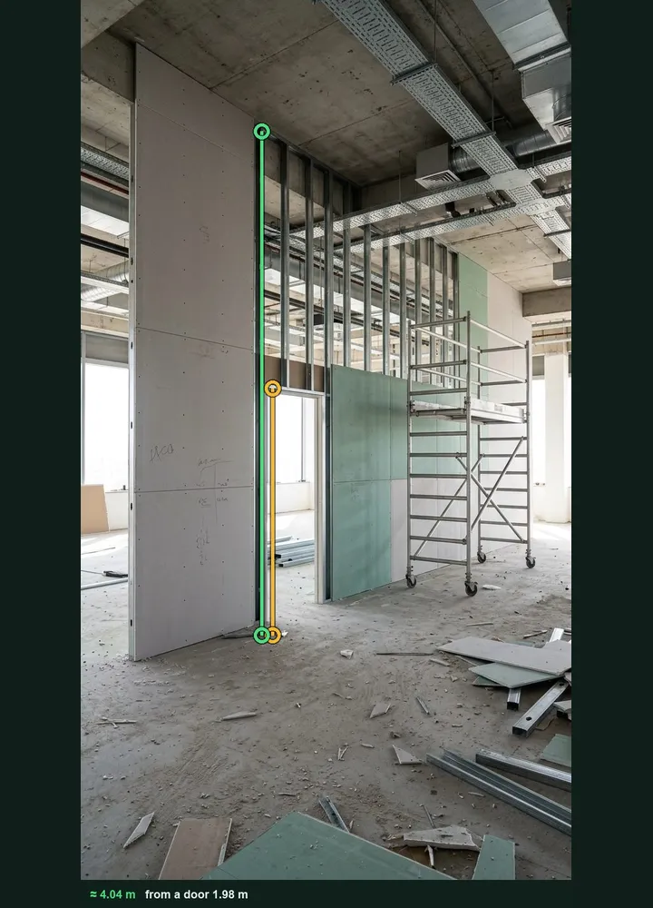 An office fit-out partition marked up in Measure from photo: an amber line on the door opening and a green line from the floor to the head track, about 4.04 m