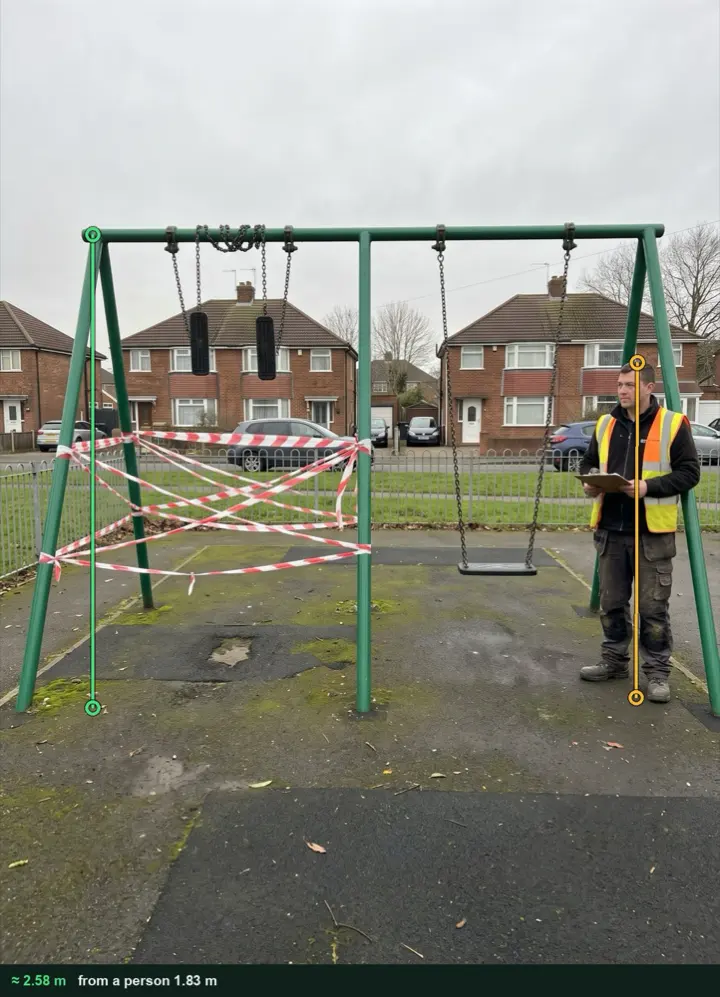 A two bay swing frame with the left bay taped off, measured from a photo at about 2.58 m from the ground to the cracked bracket, against a person 1.83 m tall