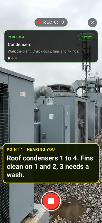 A row of rooftop air conditioning condensers, with the Walk Cam point card and live transcription
