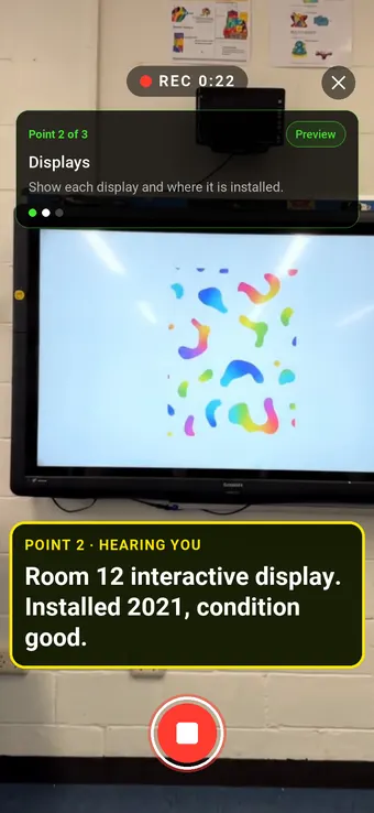 An interactive display on a classroom wall, with the Walk Cam point card and live transcription