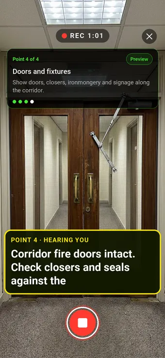 Double fire doors in an office corridor, with the Walk Cam point card and live transcription