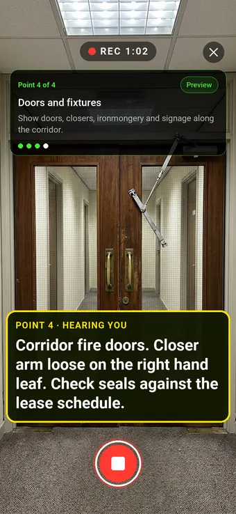 Double fire doors in an office corridor, with the Walk Cam point card and live transcription
