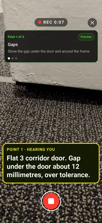The gap under a fire door in an apartment corridor, with the Walk Cam point card and live transcription