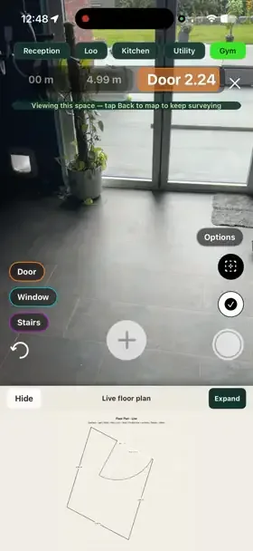 Walking room to room in SiteSurvey — each space named along the top and the live floor plan building underneath as the walk continues