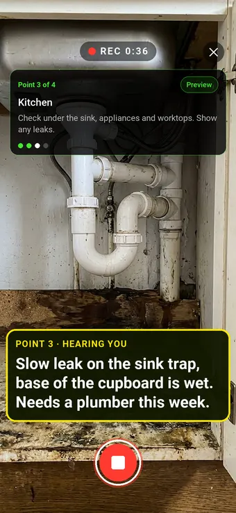 Water leaking from a trap under a kitchen sink, with the Walk Cam point card and live transcription