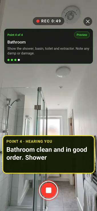 A clean rented flat bathroom with a shower enclosure, with the Walk Cam point card and live transcription