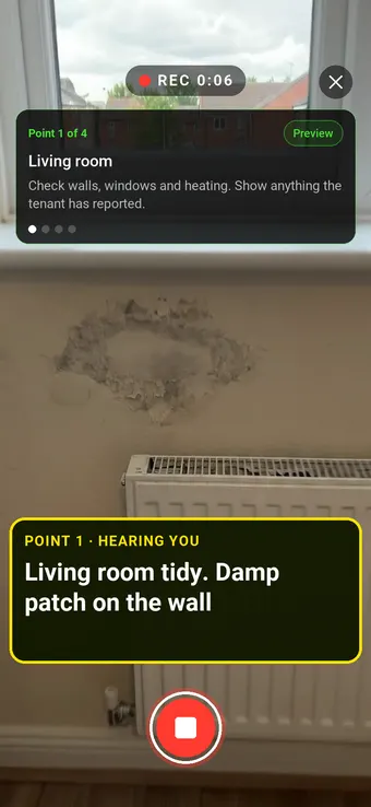 Walk Cam recording a damp patch on a rented flat's living room wall, with the point card and the live transcription on screen