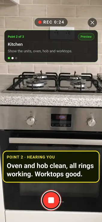 An empty rental flat kitchen with oven and hob, with the Walk Cam point card and live transcription