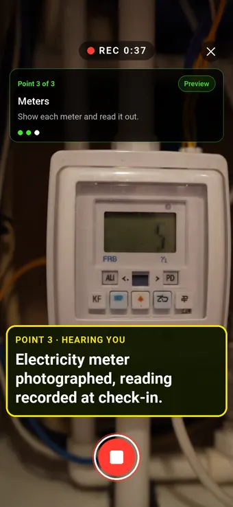 An electricity meter in a hallway cupboard, with the Walk Cam point card and live transcription