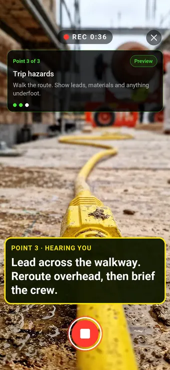 An extension lead running across a site walkway, with the Walk Cam point card and live transcription