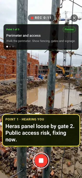A loose fence panel on a construction site perimeter, filmed with SiteSurvey Walk Cam: the point card and the live voice-to-text note of the hazard