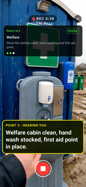 A site welfare cabin with hand-wash station and first aid point, with the Walk Cam point card and live transcription