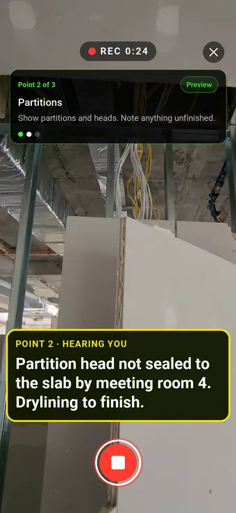 A plasterboard partition with an unfinished head, with the Walk Cam point card and live transcription