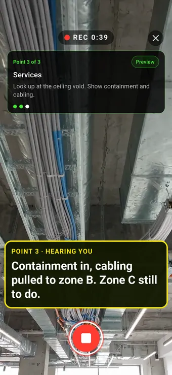 An open ceiling void with containment and cabling, with the Walk Cam point card and live transcription