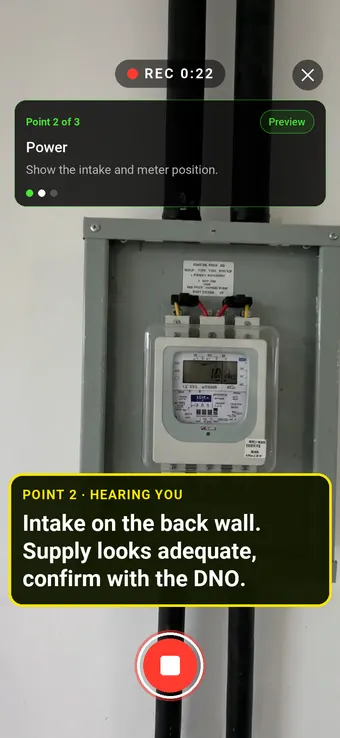 An electrical intake and meter on a retail unit wall, with the Walk Cam point card and live transcription