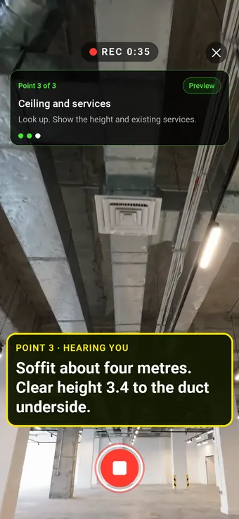 An exposed retail unit ceiling with ductwork, with the Walk Cam point card and live transcription