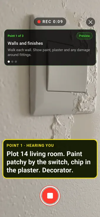 A chipped wall beside a light switch in a new apartment, with the Walk Cam point card and live transcription