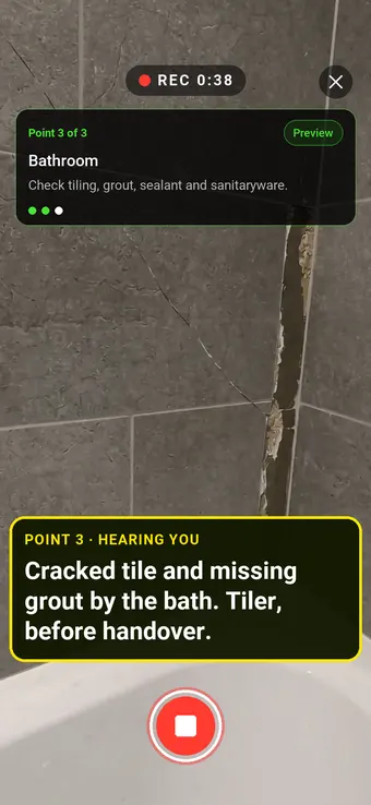 A cracked tile and missing grout beside a bath, with the Walk Cam point card and live transcription