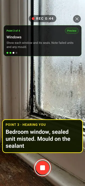 A misted double-glazed window with mould on the sealant, with the Walk Cam point card and live transcription