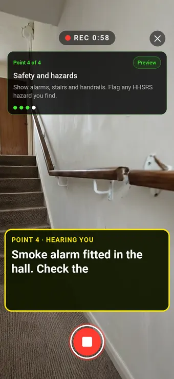 A hallway smoke alarm and staircase with a handrail, with the Walk Cam point card and live transcription