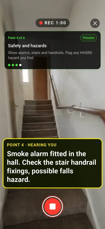 A hallway smoke alarm and staircase with a handrail, with the Walk Cam point card and live transcription